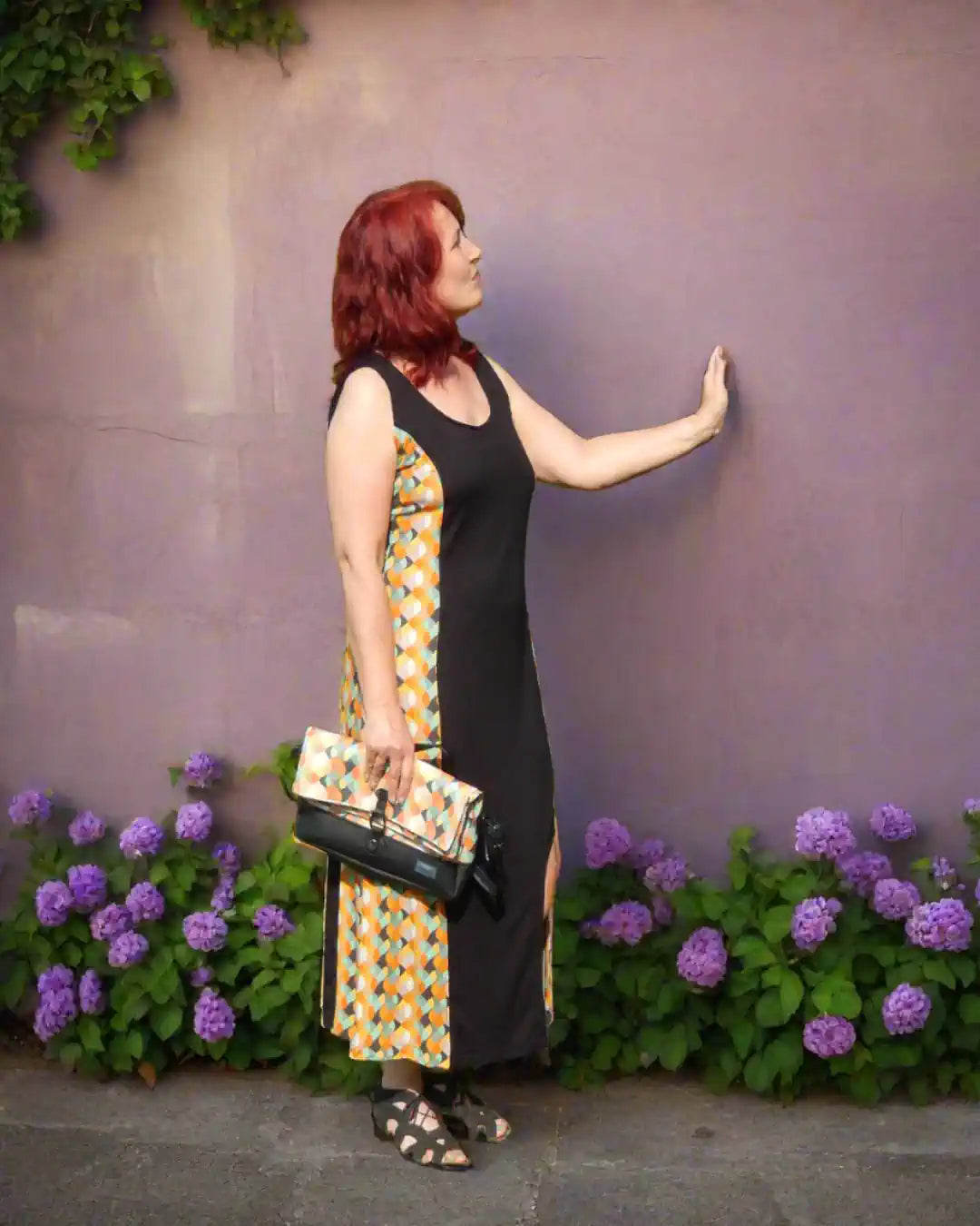 Langes Sommerkleid in schwarz/retro, mit Cutout am Bein, mit farblich passender Handtasche