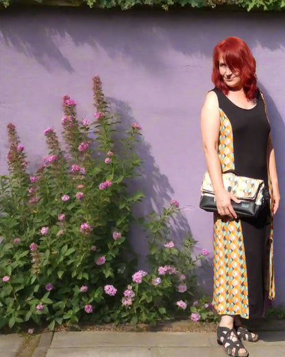 Langes Sommerkleid in schwarz/retro, mit Cutout am Bein, mit farblich passender Handtasche